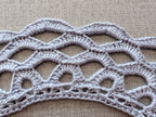 The completed Chart 117 handmade crochet lace collar laid gracefully.