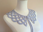 A stylish crochet lace collar layered elegantly, demonstrating the smooth drape, 9-centimeter depth, and romantic statement look of the finished accessory.