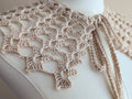 Finished ivory crochet lace collar with shell stitch details and ties laying flat, created from Chart 103 pattern.