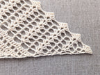 Close-up shot of the decorative scalloped shell border along the edge of the crochet triangle shawl.