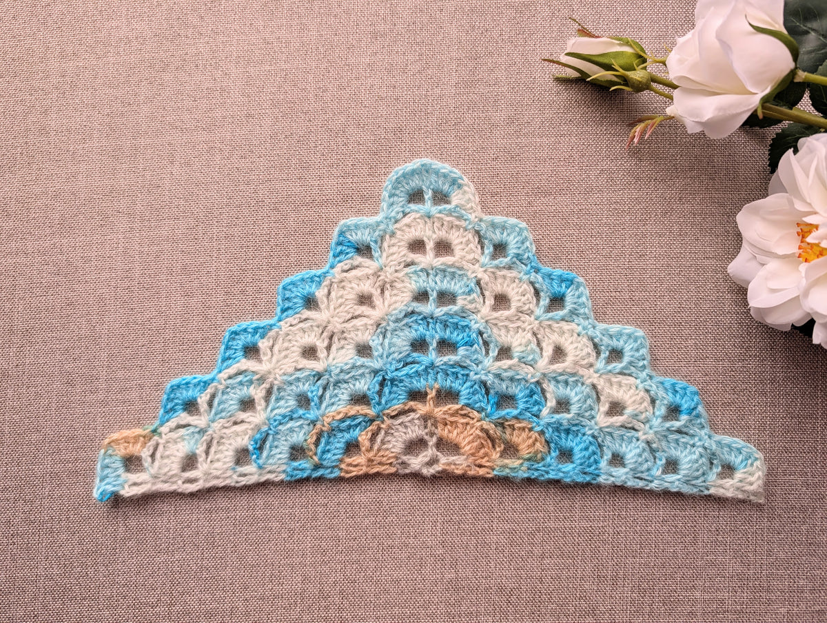 Chart No. 114 dense shell crochet triangle scarf in gradient yarn showing scalloped self-edging texture.