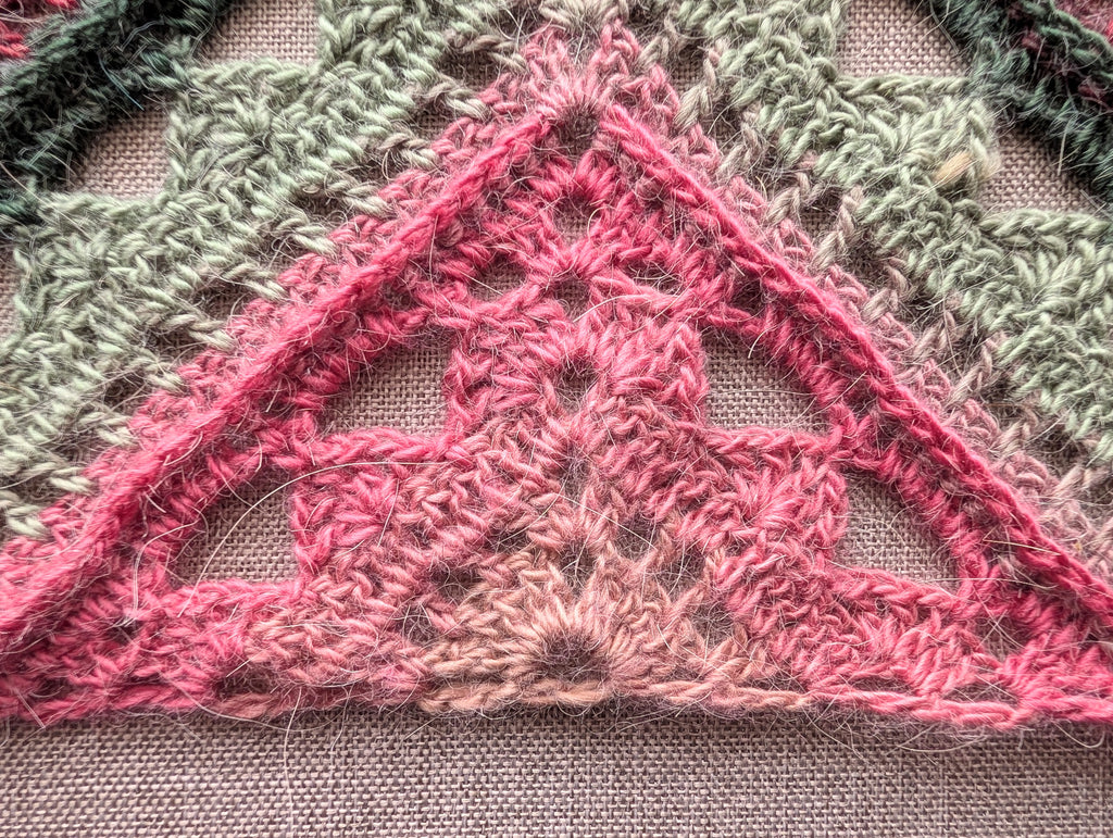Close-up detail of front-post double crochet ridges and shell lace stitches in pattern #112.
