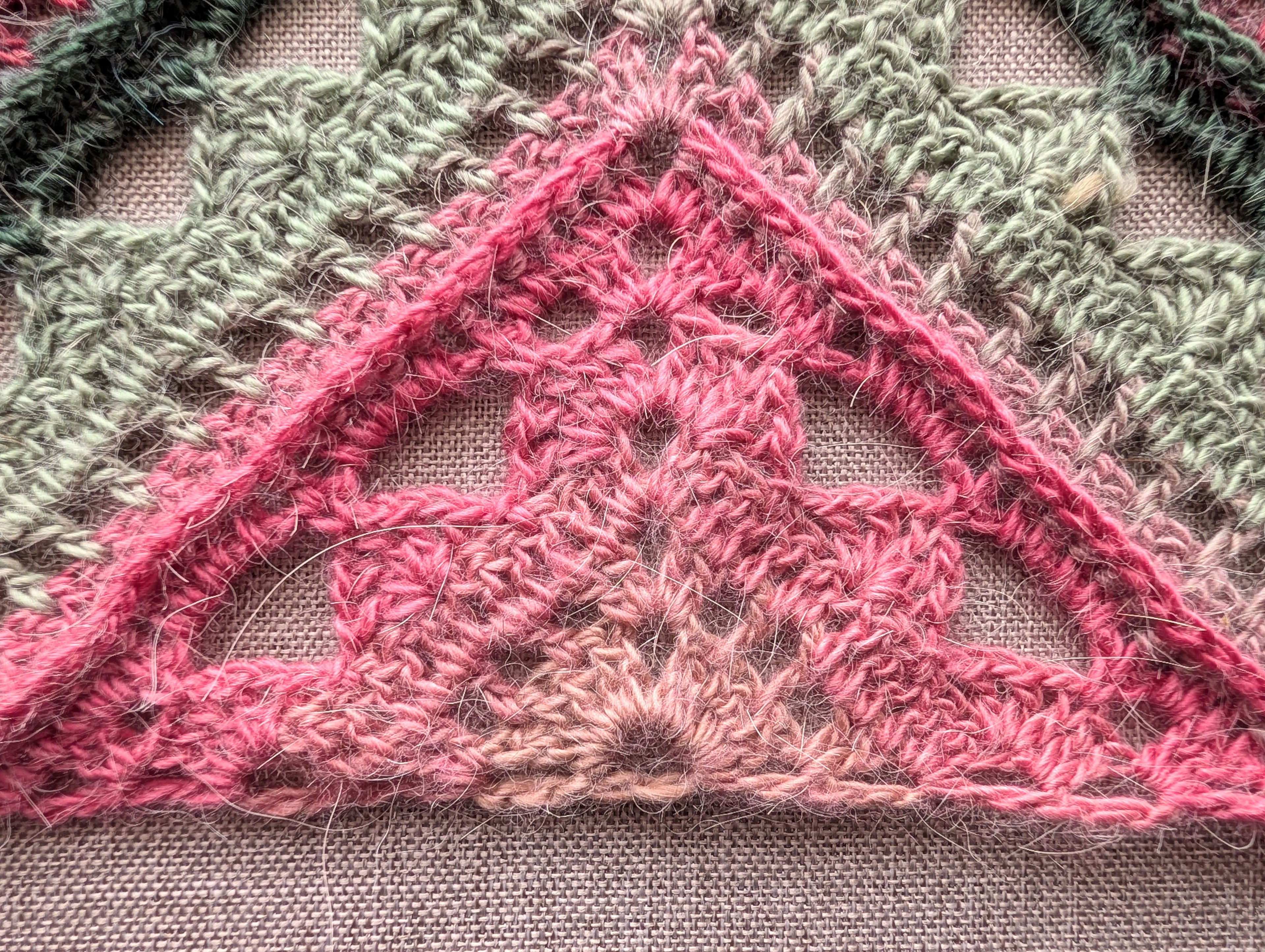 Close-up detail of front-post double crochet ridges and shell lace stitches in pattern #112.