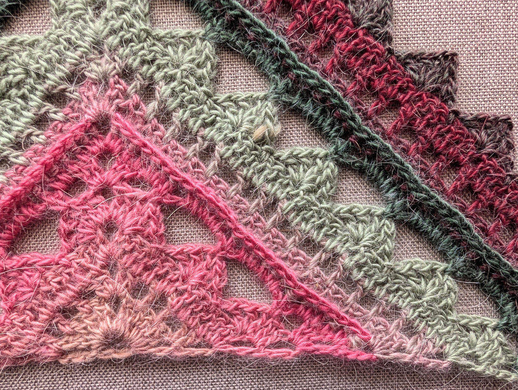 Close-up detail of front-post double crochet ridges and shell lace stitches in pattern #112.