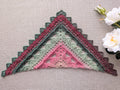 Full view of an advanced textured triangle shawl crochet pattern #112 worked in gradient color-changing cake yarn.