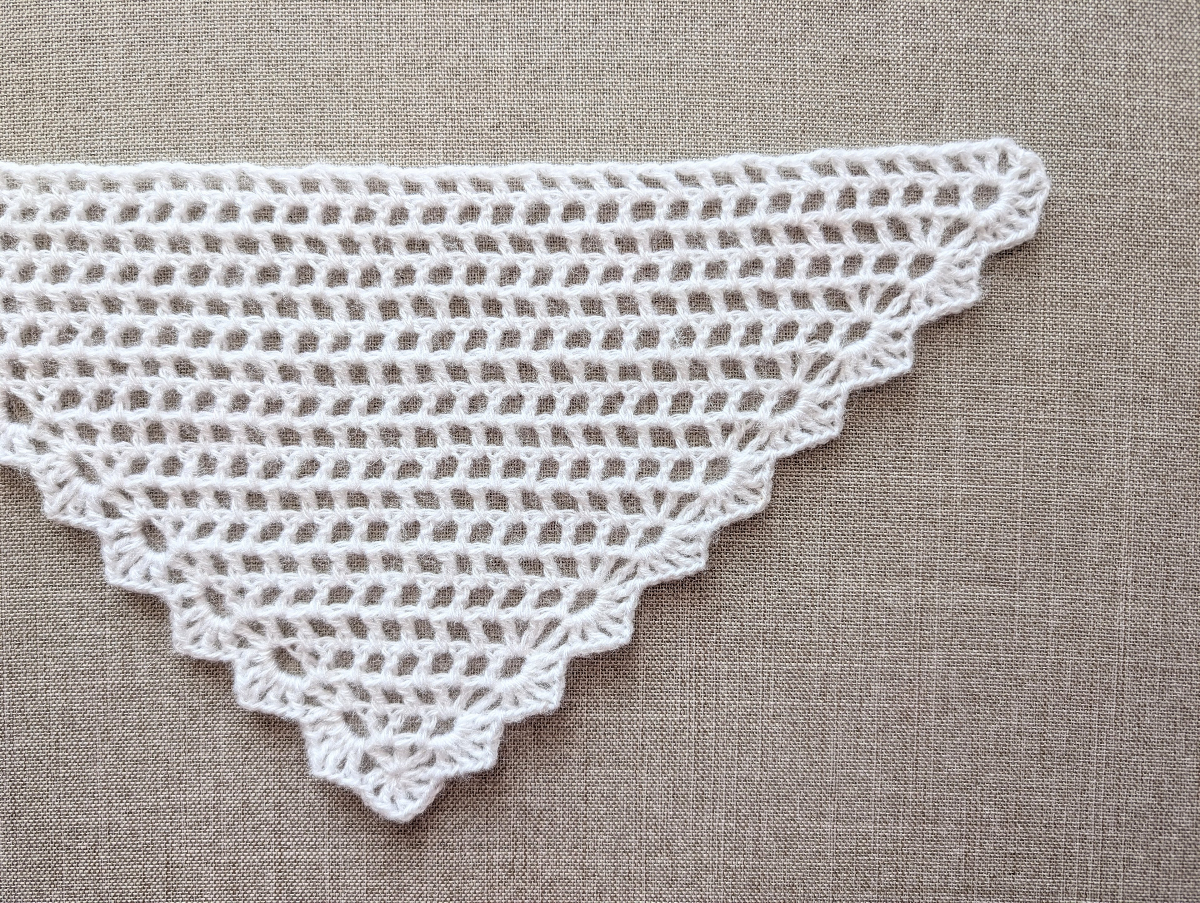 Detailed view of the finished decorative border and lace stitch edging on a triangle crochet shawl, Chart 99.
