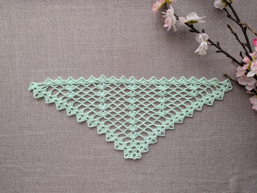Close-up detail of the intermediate crochet pattern stitches, highlighting the textured 3-dc clusters and the defined chain-space lace texture.