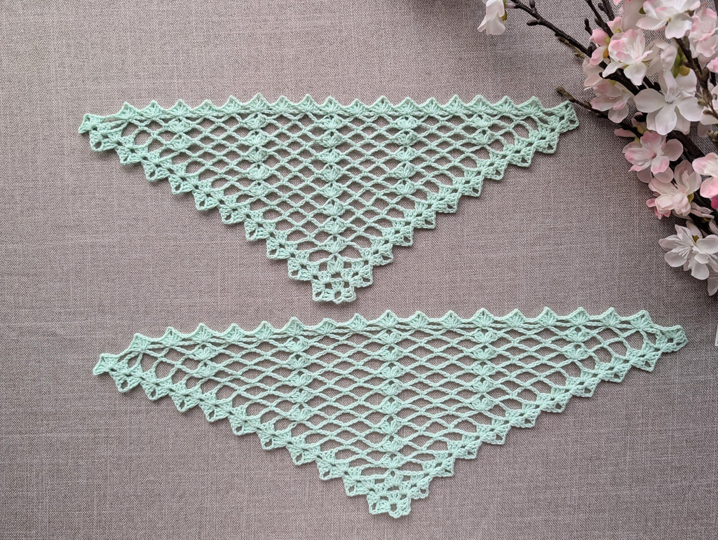 Completed crocheted lace triangle shawl featuring dimensional 3-dc cluster motifs and delicate openwork.