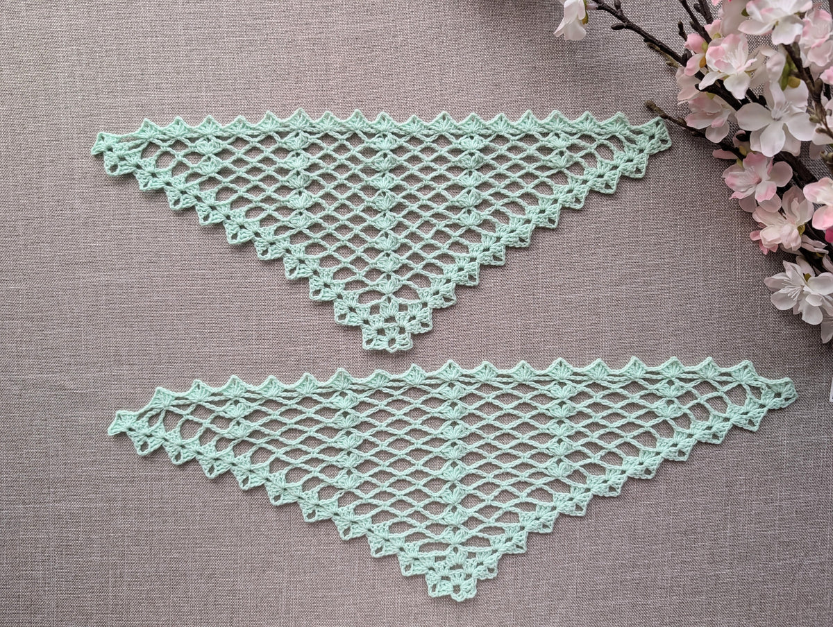 Completed crocheted lace triangle shawl featuring dimensional 3-dc cluster motifs and delicate openwork.