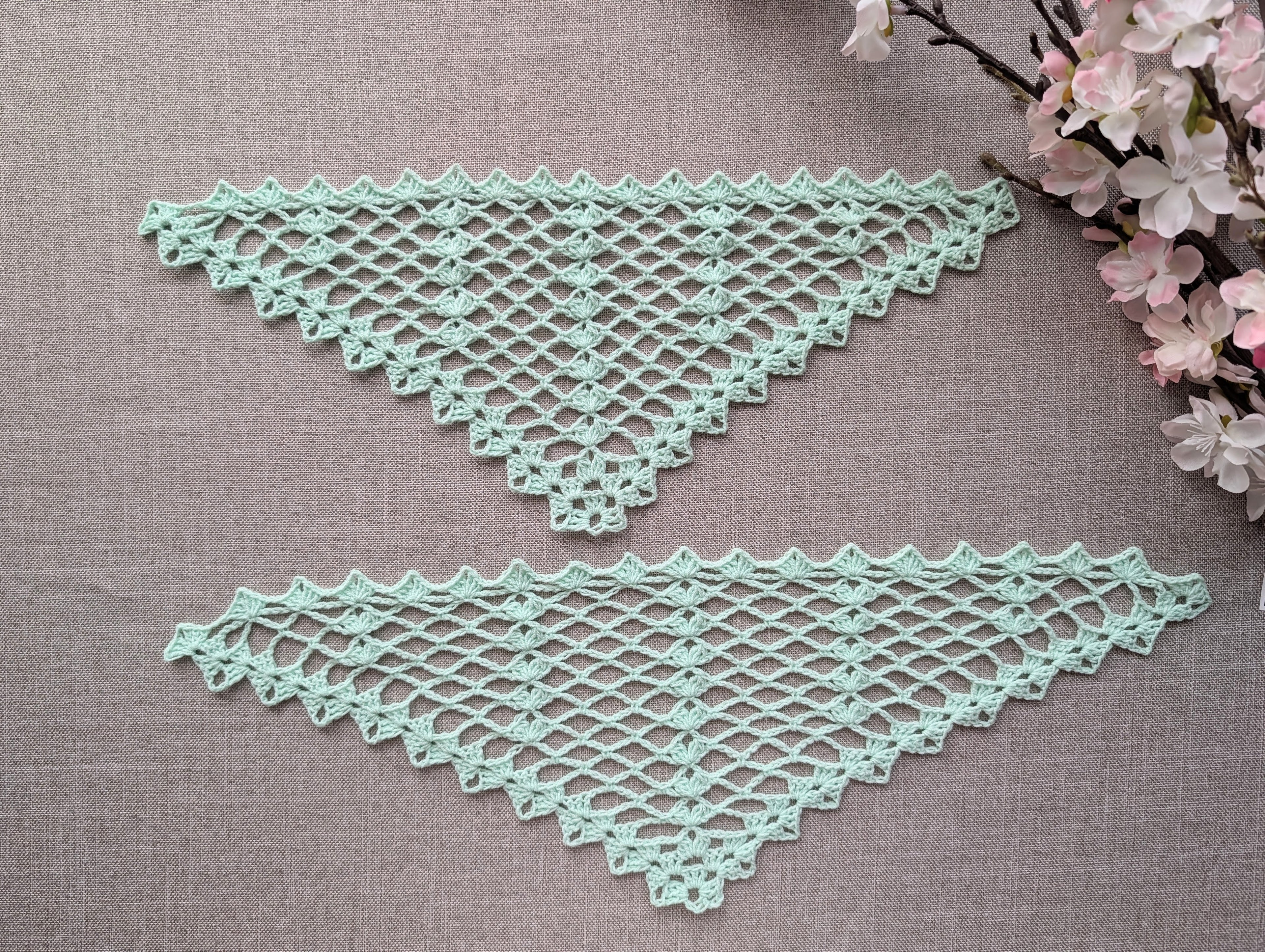 Completed crocheted lace triangle shawl featuring dimensional 3-dc cluster motifs and delicate openwork.
