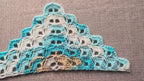 Top-down view of an intermediate crochet bandana using Chart 114 self-striping yarn.