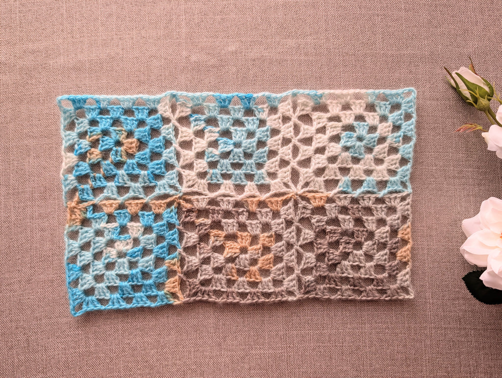 Finished seamless granny square crochet project made with continuous join-as-you-go technique using color-changing yarn.