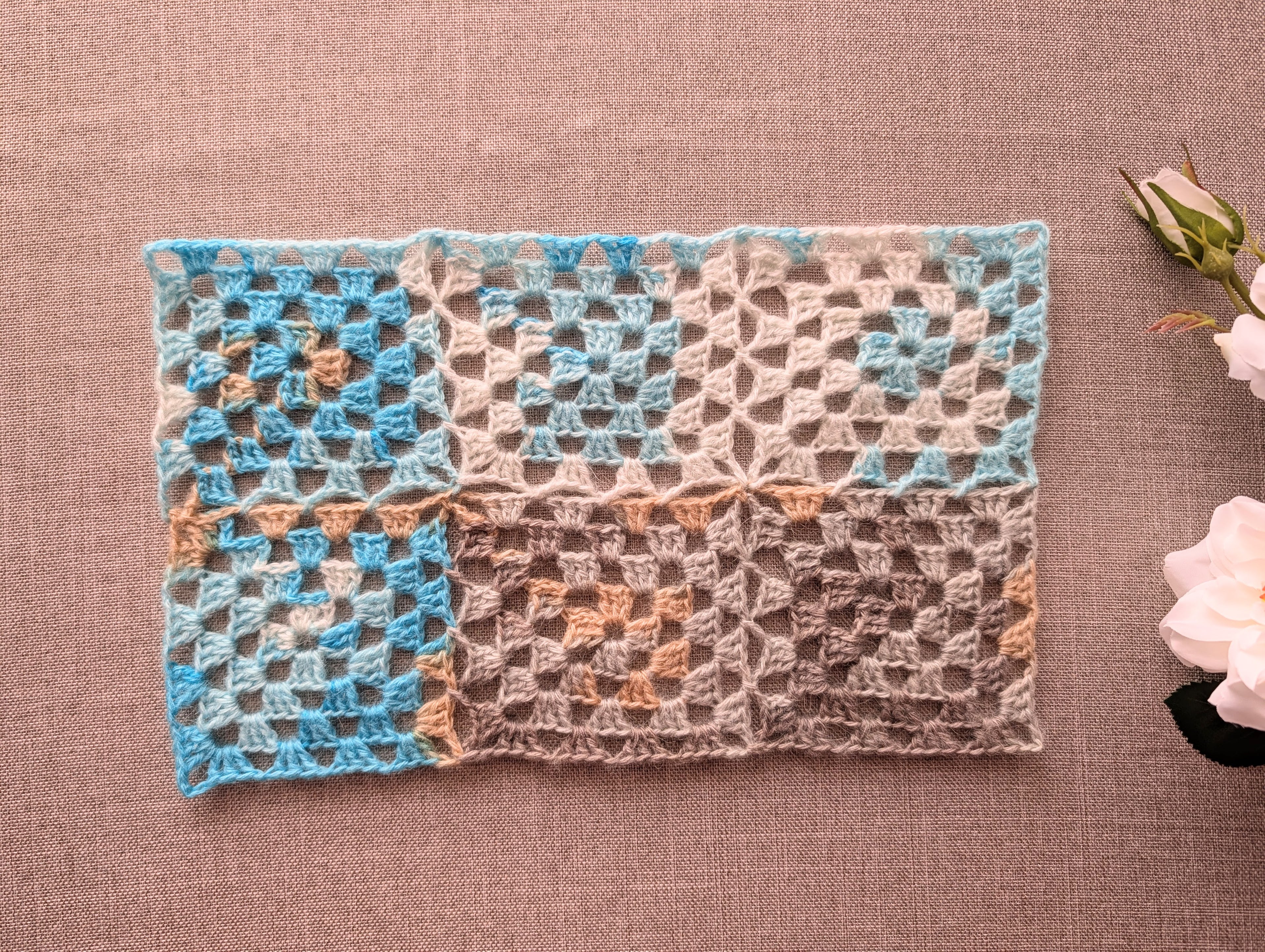Finished seamless granny square crochet project made with continuous join-as-you-go technique using color-changing yarn.
