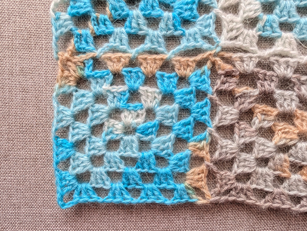 Close-up view of seamless continuous join-as-you-go granny square motifs connected without sewing or seams.
