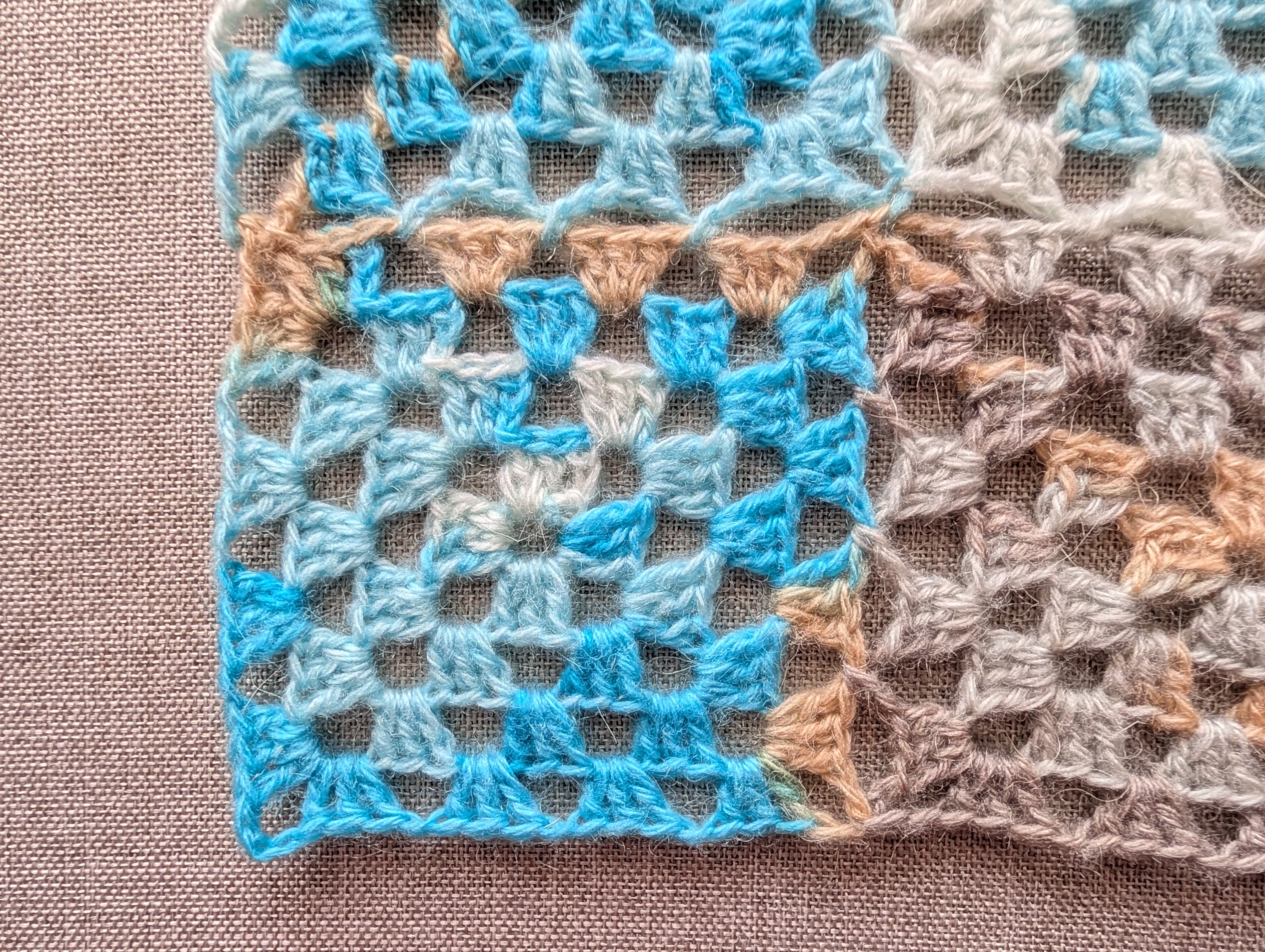 Close-up view of seamless continuous join-as-you-go granny square motifs connected without sewing or seams.