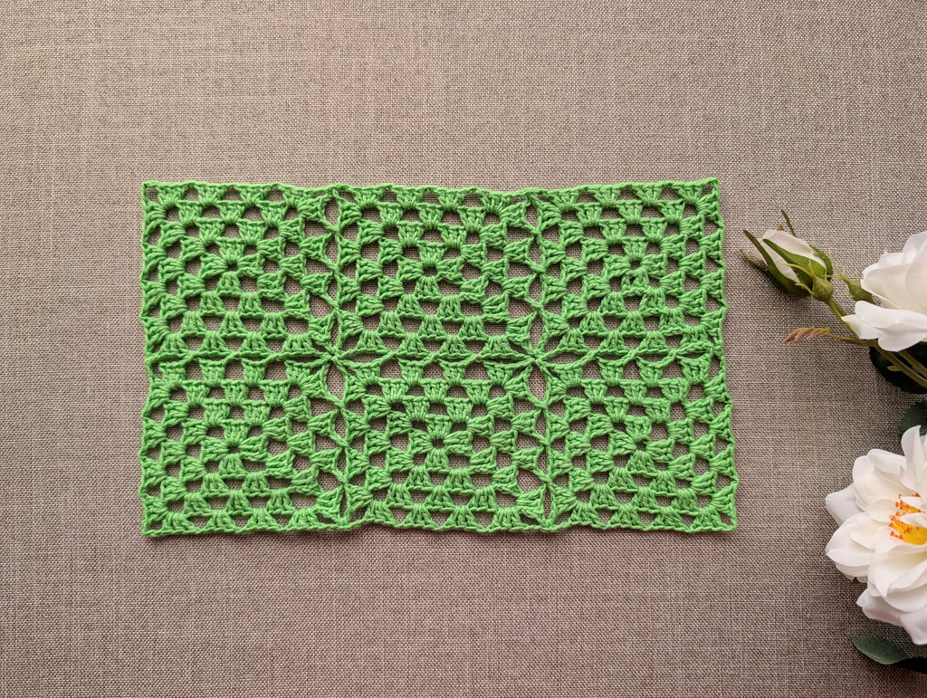 Continuous join granny square motif crocheted with soft cotton wool blend yarn showing rich stitch texture.