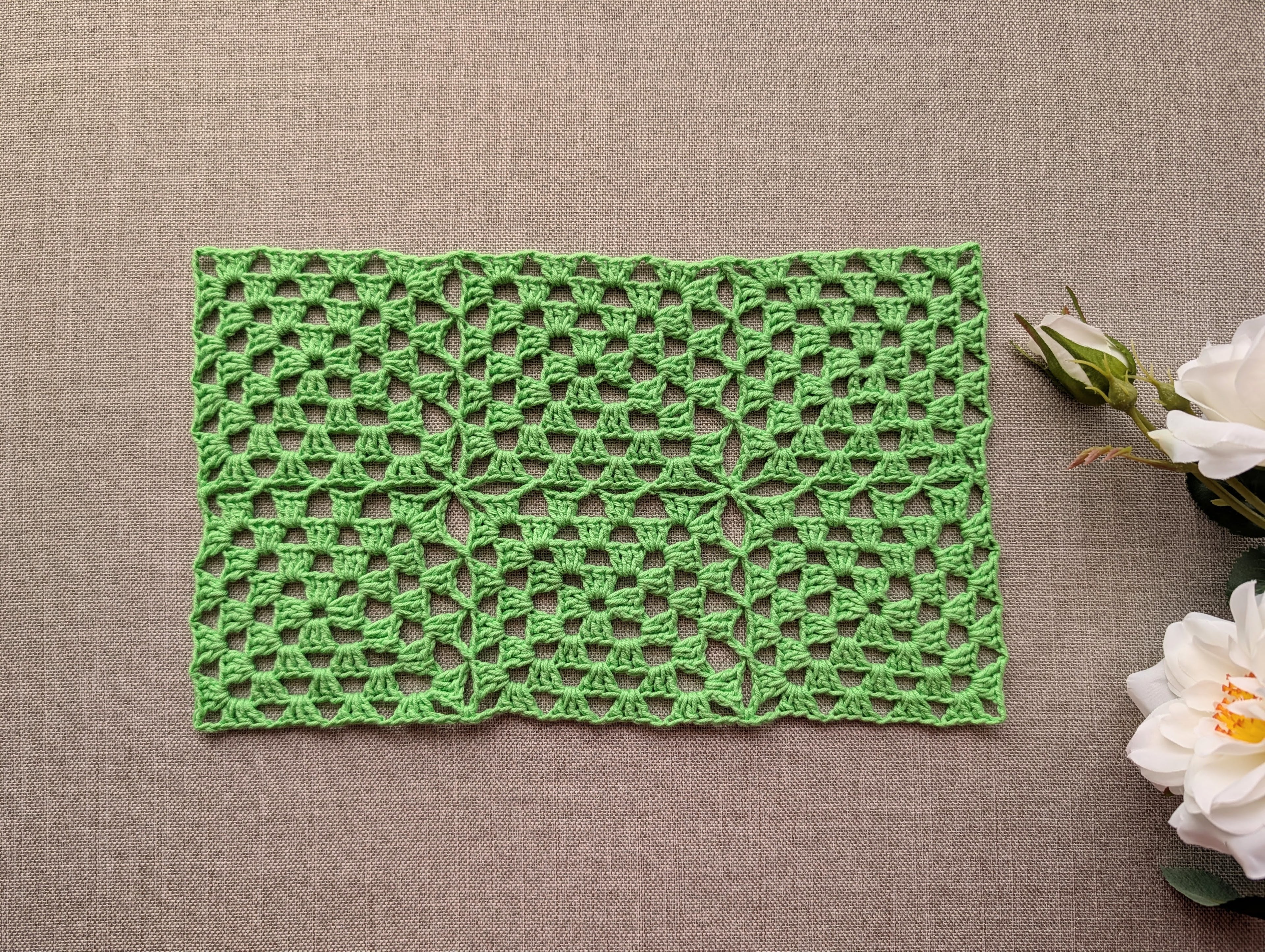Continuous join granny square motif crocheted with soft cotton wool blend yarn showing rich stitch texture.